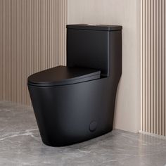 a black toilet sitting next to a wall