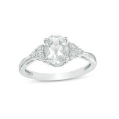 Set a sophisticated tone in this glamorous fashion ring. Crafted in sterling silver, this timeless design features an 8.0 x 6.0mm oval-shaped lab-created shimmering white sapphire flanked by trios of diamond accents - each artfully set to enhance size and sparkle. Buffed to a brilliant luster, this look glistens with elegance. Custom-made to fit her ring size. Sterling silver rings cannot be resized after purchase. Timeless White Topaz White Rings, White Rings With Accent Stones For Formal Occasions, Formal White Rings With Accent Stones, Formal White Topaz Ring With Cubic Zirconia, Classic White Topaz Ring With Round Cut, Elegant Oval Topaz Ring With Diamond Accents, Classic White Diamond Ring With Accent Stones, Classic Topaz Ring With Diamond Accents, Elegant White Topaz Ring With Brilliant Cut