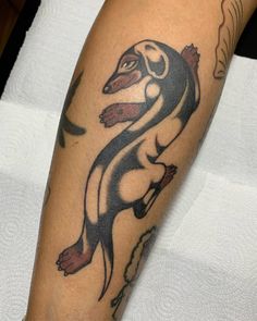 an arm with a tattoo on it that looks like a dachshund