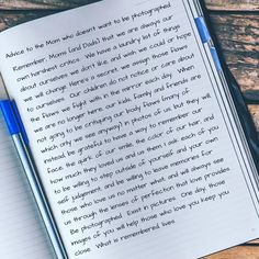 a notepad and pen sitting on top of a wooden table next to an open notebook