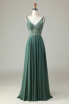 a green dress on a mannequin dummy with an open back and lace detailing