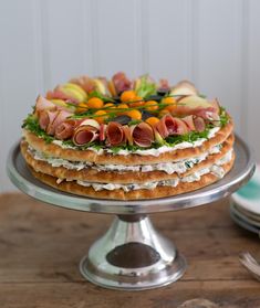 there is a cake that has been decorated with fruits and vegetables on top of it