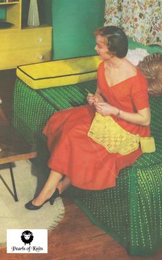 an old photo of a woman and child sitting on a green chair in front of a yellow table