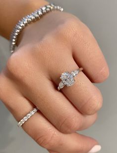 a woman's hand with a diamond ring on it