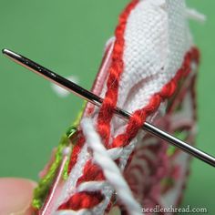 the needle is being used to crochet an object