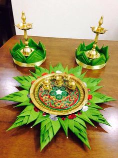 a table topped with green and gold decorations