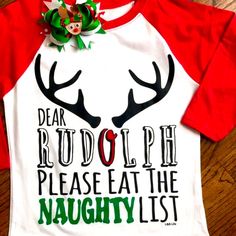 Dear Rudolph Please Eat The Naughty List Saying Across Front Of Top. A White Next Level Raglan Style With Red Sleeves. A Heat Transfer Of Rudolph Antlers With Cute Saying. Outfit Complete For The Girls A With Coordinating Bow That Is Included In Purchase. Shirt Could Be Unisex Too For Little Boys Without The Bow Of Course. Same Day Shipping If Purchases By 3pm Central. Smoke Free Home Boutique Christmas Shirt Ideas Vinyl For Kids, Funny Kids Christmas Shirts, Playful Red Christmas Tops, Fun White Christmas Tops, Playful Cotton Holiday Tops, Cute Red Holiday Tops, Playful Cotton Tops For The Holiday Season, Fun White Holiday Tops, Cute White Top For Festive Occasions