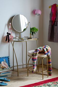 a room with a chair, mirror and other items on the floor in front of it