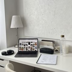 a laptop computer sitting on top of a white desk