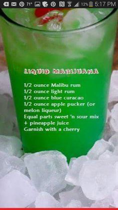 a green drink with a cherry on the top