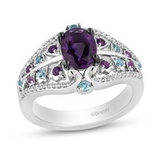 Grant yourself a fairytale look with this multi-gemstone and diamond ring from the Enchanted Disney Fine jewelry Collection inspired by Disney’s Wish. Sterling silver. Showcases an 8.0 x 6.0mm oval-shaped amethyst center stone. Dainty amethyst, Swiss blue topaz and diamond-lined borders decorate the design. 1/6 ct. t.w. of diamonds. Available in size 7 only. ©Disney. Disney Inspired Rings, Disney Wish, Engagement Ring Necklace, Enchanted Disney, Enchanted Disney Fine Jewelry, Disney Fine Jewelry, Gemstone Ring Silver, Amethyst Jewelry, Swiss Blue Topaz