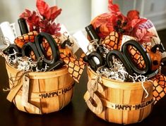 two wooden baskets filled with happy halloween decorations