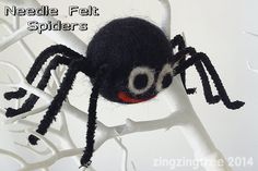 there is a black spider with red eyes on it's head