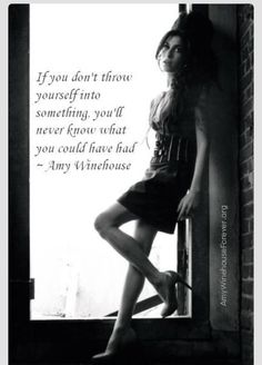 a woman leaning on a window sill in front of a brick wall with an inspirational quote