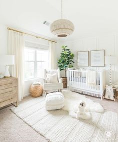 a baby's room with white furniture and rugs on the floor, including a crib