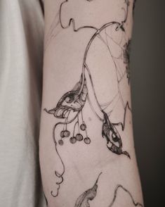 a woman's arm with a tattoo design on the left side of her body