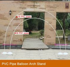 an arch made out of wood and metal stands in front of a brick building with the words p vc pipe balloon arch stand on it