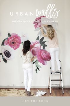 two women painting flowers on the wall with words urban walls modern faces, full life's spaces