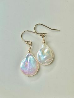 "Dainty 14k gold filled ear wires have sweet, luminous freshwater pearl dangles... like decadent whipped frosting! The approx 1/2\" wide pearls are all special & individually glowing with faint multi-colors. Pearls symbolize purity, harmony & humility, plus being the birthstone for June. A special occasion earring, a bridal choice or simply a pair of earrings to wear with anything at anytime. Each pair is unique- chose your fav at check out. These pearl dangles were created uniquely in my Seattl Multicoloured Earrings, Whipped Frosting, Natural Pearl Earrings, Bridal Gift, Funky Jewelry, Natural Pearl, Pearl Earrings Dangle, Natural Pearls, Cute Earrings