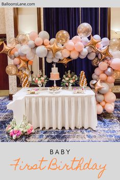 a table topped with balloons and a cake