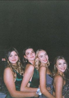 four young women are posing for the camera