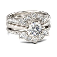 a white gold engagement ring set with an intricate flower design and round brilliant cut diamonds