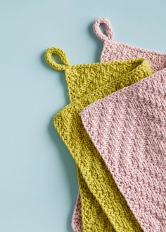 three crocheted dishcloths on top of each other, one pink and one green