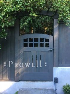 an open gate with the word prowell written on it in front of a house