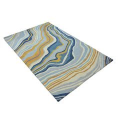 a blue and yellow area rug with wavy lines on the top, in front of a white background