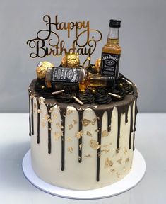 a birthday cake with chocolate icing and gold decorations