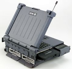 an open laptop computer sitting on top of a hard drive case with its lid open