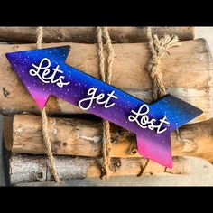 a wooden sign that says let's get lost on the side of a log