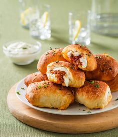 a white plate topped with rolls covered in cheese