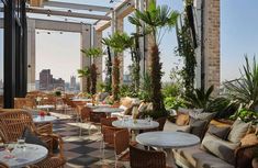 an outdoor restaurant with lots of tables and chairs