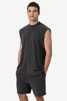 A sleeveless, cutoff version of our bestselling 1801GD Garment Dye T-shirt. This unisex muscle tank features a crew neckline with deep, raw-hemmed sleeves. Made of 100% USA cotton, this textile is beefy, durable, and absorbent, and is virtually shrink free as a result of garment dyeing. The garment is washed with natural enzymes, resulting in a broken-in feel, just like a T-shirt that was washed or worn for a decade or two. Made in Los Angeles, Calif. Our experienced sewers earn up to $25 an hou Lace Knitwear, Kids Garments, Summer 2025, Sweater Jumpsuit, Denim Sweater, Cool Outfits For Men, Sleeveless T Shirt, Sleeveless Tee, Leather Denim