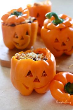 several carved pumpkins with faces on them