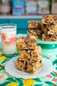 chocolate chip cookie bars stacked on top of each other next to a glass of milk