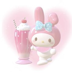 a hello kitty figure next to a pink milkshake