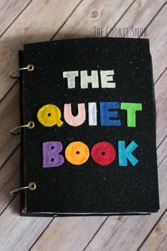 the quiet book is decorated with crayon letters and black paper, which reads'the quiet book '