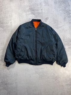 This vintage MA-1 men's jacket is a must-have for any fashion-savvy individual. The jacket features a navy blue solid pattern and is made of high-quality nylon material. It has a short length and a regular fit, making it suitable for any occasion. The jacket is also reversible and has a full zip closure, adding to its versatility. The jacket is perfect for those who love the 90s theme and are looking for a unique piece to add to their wardrobe. It is suitable for winter, fall, and spring seasons Love The 90s, 90s Theme, Vintage Men, Unique Pieces, Mens Jackets, Bomber Jacket, Jackets & Coats, Navy Blue, Mens Outfits