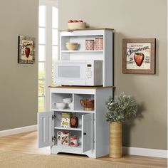 a white microwave oven sitting on top of a cabinet