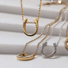 A refined necklace that showcases our bold new design, the Classique Horseshoe Pendant and Rolo Chain Necklace in 14K Gold on Sterling Silver exudes timeless elegance. Featuring a chunky yet graceful horseshoe pendant paired with a wide Rolo chain, this necklace captures light beautifully. The adjustable chain threads seamlessly through the horseshoe, secured by a sturdy lobster clasp. An ideal choice for those seeking professional yet stylish versatility, it blends EQ Elegance with modern charm Formal Yellow Gold Horseshoe Jewelry, Elegant Gold Horseshoe Jewelry, Gold Horseshoe Jewelry With Adjustable Chain, Gold Horseshoe Necklace For Formal Occasions, Formal Gold Horseshoe Necklace, Elegant Gold Horseshoe Necklace, Elegant Yellow Gold Horseshoe Necklace, Gold Horseshoe Necklace With Adjustable Chain, Elegant Horseshoe Necklace For Everyday