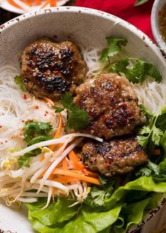 two meatballs and some vegetables in a bowl