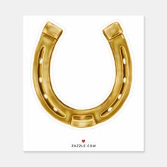 a gold horseshoe shaped sticker on a white background