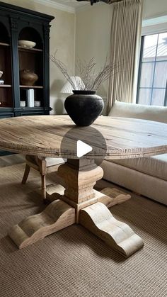 a large wooden table sitting in front of a couch