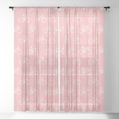 a pink curtain with white bicycles on it