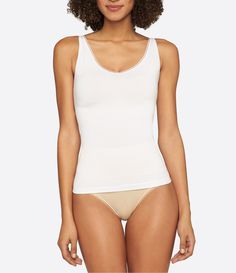 From the Seamless Shape collection by Yummie by Heather Thomson&#x2C; this tank features:ultra-light temperature-controlling fabricpicot trimV-neckline and scoop back for reversible wearbuilt-in shelf braTencel /Outlast nylon/spandexmachine washImported. Shapewear Tank Top With Built-in Bra And Wide Straps, White Elastane Tank Top With Built-in Bra, Seamless Tank Top For Layering, Stretch Camisole For Layering, White Tight-fitting Seamless Tank Top, White Seamless Scoop Back Top, White Tank Top With Built-in Bra, White Seamless Top With Scoop Back, White Seamless Tops With Scoop Back