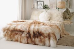 a fur covered bed in a white room