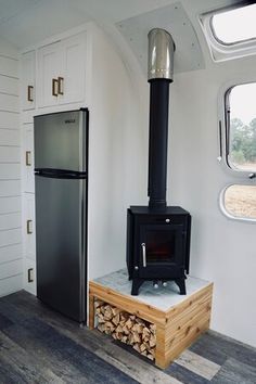 a stove in the corner of a room next to a refrigerator