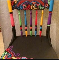 a colorfully decorated chair sitting on top of a floor